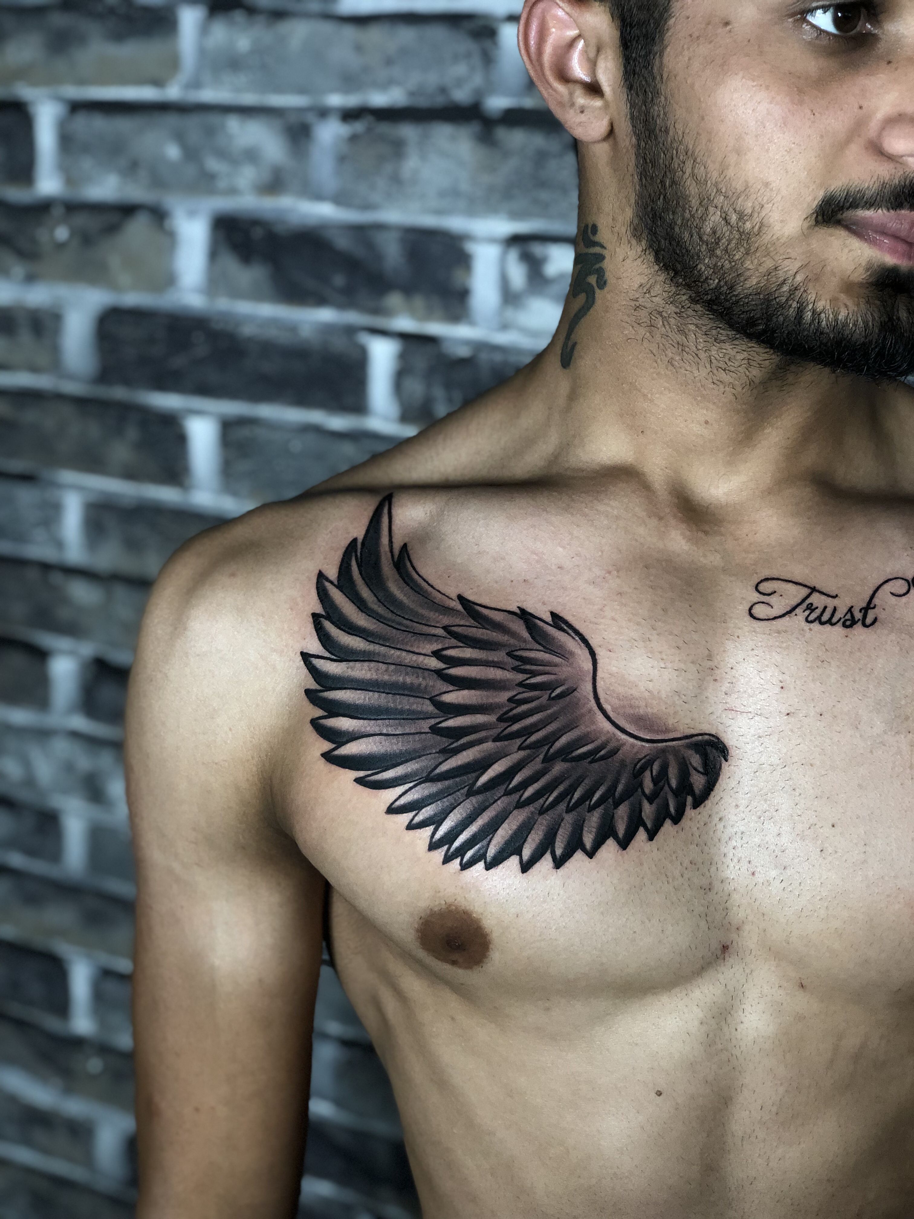 small wings tattoo on chest