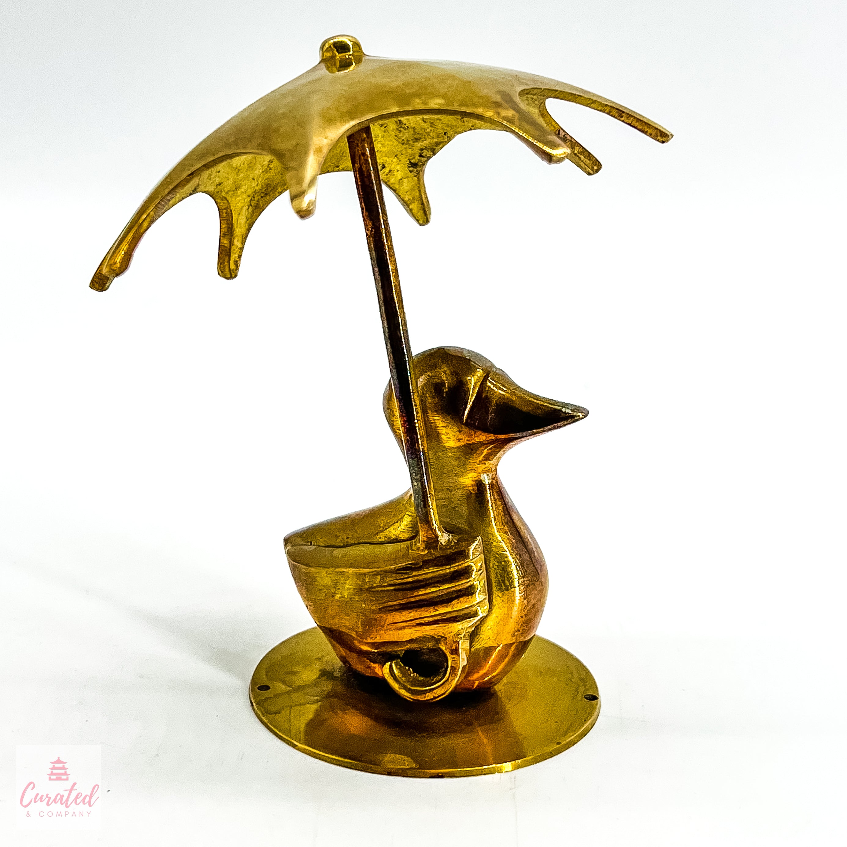 brass duck with umbrella