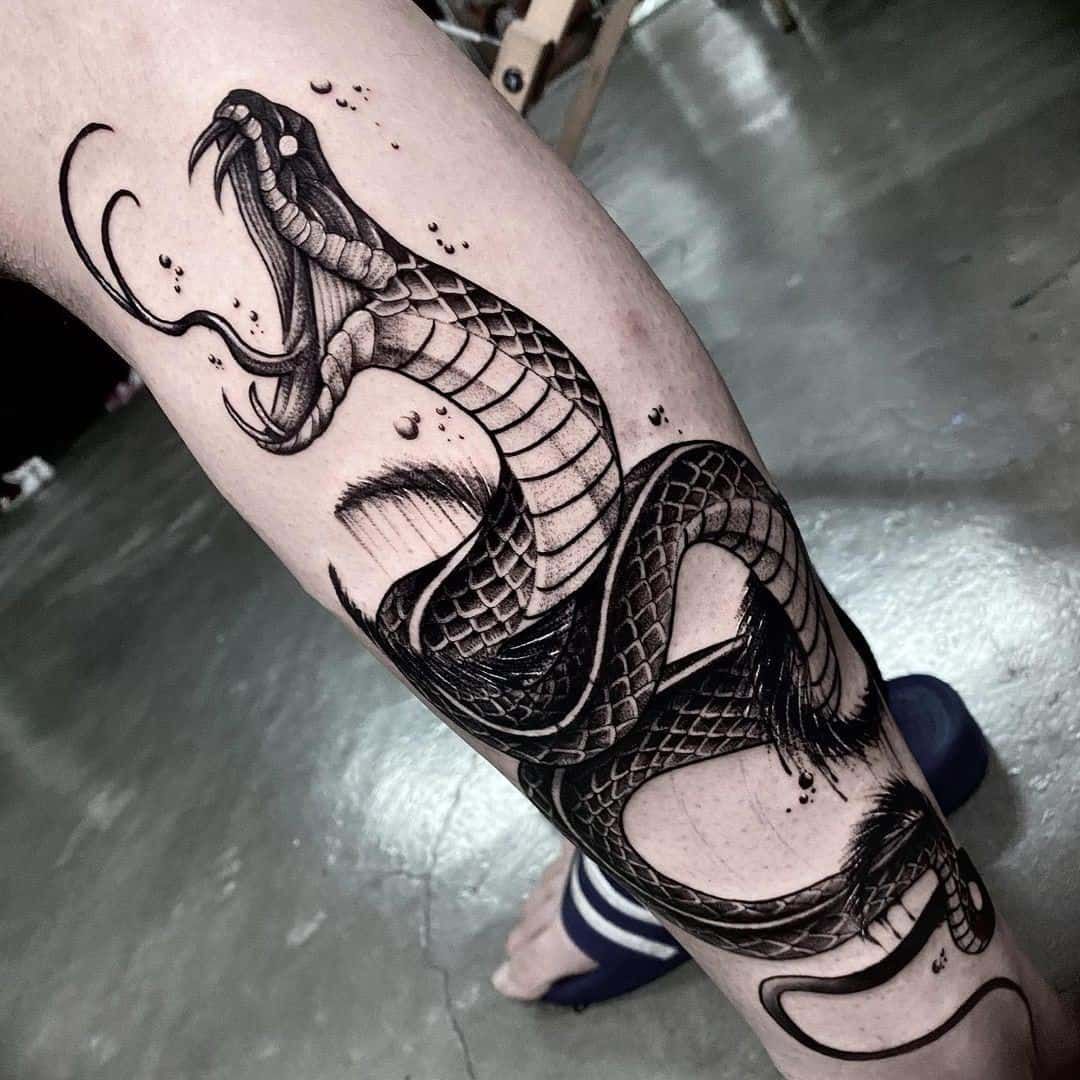 cobra tattoo on leg