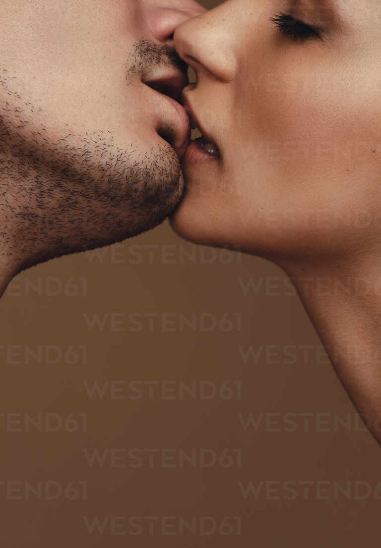 man and woman kissing passionately